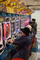Shinjuku  Kabuki-cho.  Japanese men and women betting on electronic gambling machines.gamesgamblerelectricmodern lifecultureFar EastAsia Asian Female Woman Girl Lady Male Man Guy Nihon Nippon