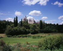 Chteau de Pierrefonds dating form the 14th century. Restored by Viollet-le-Duc from 1857 on the orders of Napoleon III. Turrets and crenellated walls seen above trees. Used as location set for BBC pr...