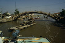 Barges travelling under bridge on the Grand Canal between Suzhou and Wuxi. Asia Asian Chinese Chungkuo Jhonggu Zhonggu Traveling