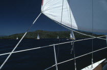 Flotilla sailing Cobra 850 s. View from deck of yacht with section of white sail on the South Ionian Sea