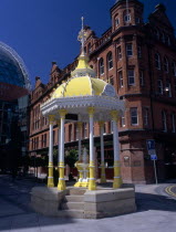 Victoria Square.  Yellow and white canopied Jaffe Fountain  constructed in 1874 as memorial to Daniel Joseph Jaffe in front of brick exterior facade of Bittles Bar.nineteenth century 19th c Bal Feir...