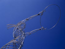 Oxford Street.  Angled  part view of modern metal sculpture from low viewpoint looking up  depicting female figure holding up hoop against cloudless blue sky.Bal Feirste Eire European Irish Northern...