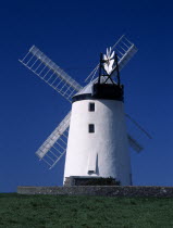Ballycopeland Windmill.  White painted windmill standing against blue  cloudless sky.Eire European Farming Agraian Agricultural Growing Husbandry  Land Producing Raising Irish Northern Europe Republi...