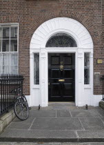 Georgian doorway near Merrion Square with black door and bicycle outsideIreland Eire Dublin Georgian Architecture Doorways