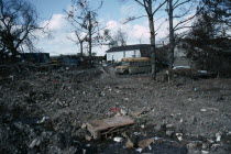 Aftermath of 2005 Hurricane Katrina  rubble from destroyed houses  stranded vehicles  mud and stagnant water. winddisasterstorm American North America United States of America