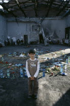 Child standing in front of tributes left in school destroyed during 2004 siege by Chechen rebels in which hundreds died  the majority  children.North CaucasusNorth Ossetia-AlaniaChechnyaChechnyen...