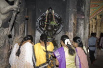 Female worshippers praying in front of a Ganesh shrine Meenakshi TempleSreeSriMeenakshiTempleMaduraiTamilNaduSouthSouthernIndiaIndianAsiaAsianHorizontalInsideIndoorInteriorCultureCu...