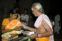 Brahmin blessing a baby held in his mothers arms at Meenakshi TempleMeenakshi AmmanSouthSouthernIndiaIndianAsiaAsianBrahminBrahmanaBrahmanPriestHorizontalCultureCulturalReligionReligio...