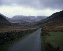 View south along Nant Francon Valley from the old road towards Snowdonia seen with a light snow cover. Skyline ridge left to right Tryfan mountain 917metres  3004 feet  Glyders mountain 996metres  326...