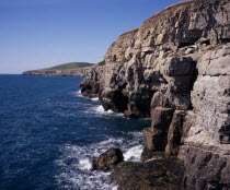 View west from Dancing Ledge towards Seacombe Quarry with grassy hilltop of East Man circa 107 metres  350 feet European Scenic Great Britain Male Men Guy Northern Europe UK United Kingdom