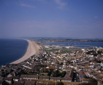 Elevated view over Chesil Beach from cliff path above town of Fortuneswell on Isle of Portland. Portland Harbour seen on the right.European Scenic Beaches Great Britain Northern Europe Resort Sand Sa...