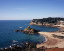 St. Brelade. Portelet Bay with Isle au Guerdain a tower built on a tidal island seen in the centreAlso known as Janvrins Tomb Named after Captain Janvrin buried there after he died of plague aboard h...