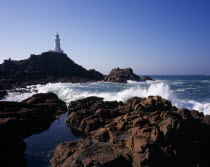 St Brelade. Corbiere Lighthouse with waves crashing against rocky foreshoreLa Corbiere European Scenic Northern Europe