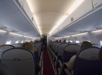 Interior of Embraer passenger jet in flght.Holidaymakers Tourism Tourist