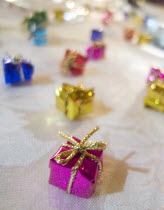 Minature wrapped Christmas presents used as festive dinner table decorations.Cultural Cultures European Order Fellowship Guild Club Religion Religious Xmas