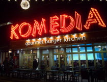 Exterior of the Komedia Theatre, cafe and bar in Gardner Street. Illuminated at night with neon signs.