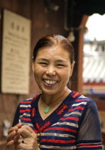 Portrait of a smiling woman  an Arhat Temple incense stick maker in outer courtyard of this 1000 year old temple much of which survived the Cultural RevolutionAsia Asian Chinese Chungkuo Jhonggu Zho...