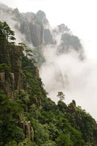 Huangshan or the Yellow Mountain. Rock peaks with lush green pine trees and a sea of cloud. Has inspired countlless painters and poets over the ages and has a 1200-year history as a tourist attraction...