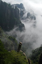 Huangshan or the Yellow Mountain. Rock peaks with lush green pine trees and a sea of cloud. Has inspired countlless painters and poets over the ages and has a 1200-year history as a tourist attraction...