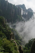 Huangshan or the Yellow Mountain. Rock peaks with lush green pine trees and a sea of cloud. Has inspired countlless painters and poets over the ages and has a 1200-year history as a tourist attraction...