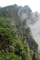Huangshan or the Yellow Mountain. Rock peaks with lush green pine trees and a sea of cloud. Has inspired countlless painters and poets over the ages and has a 1200-year history as a tourist attraction...