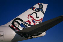 Boeing 747-400 at Gatwick Airport operated by British Airways. Detail of tail design by artist Joe David from Canada entitled Whale RiderCanadian European North America