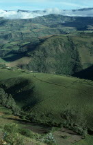 Elevated view across tundra region with green hills  valleys and agricultural terracingAmerican Equador Hispanic Latin America Latino Scenic South America Ecuador