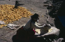 Woman grinding maize. Near Cochabamba.American Farming Agraian Agricultural Growing Husbandry  Land Producing Raising Agriculture Bolivian Female Women Girl Lady Hispanic Latin America Latino One ind...