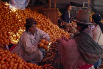 Woman selling oranges from her market stallAmerican Bolivian Female Women Girl Lady Hispanic Latin America Latino South America