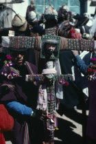 Tingku Festival Day. Man holding a large decorated cross with the face of Jesus Christ. North of PotosiAmerican Bolivian Hispanic Latin America Latino Male Men Guy Religious South America