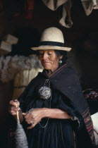Woman holding wool spindle American Bolivian Female Women Girl Lady Hispanic Latin America Latino One individual Solo Lone Solitary South America