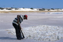 Salt Mine worked by Guajiro / Wayu Indians. Male worker wearing a red baseball cap digging the salt.WayuuAmerican Colombian Columbia Hispanic Latin America Latino One individual Solo Lone Solitary S...