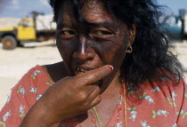 Head and shoulders portrait of a woman cake seller eating a piece of cake at the Manaure Salt Mine which is worked by Guajiro / Wayu IndiansWayuuAmerican Colombian Columbia Female Women Girl Lady Hi...