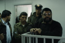 Dr Abdel Aziz al Rantissi standing in a cage / dock inside an Israeli courthouse. The co-founder and political leader of Hamas a Palestinian militant Islamist organisation in the Gaza Strip. Assassina...