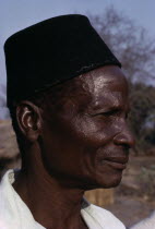 Head and shoulders portrait side profile of a man from the Yau tribe wearing a black hatAfrican Eastern Africa Indigenous Malawian Male Men Guy One individual Solo Lone Solitary