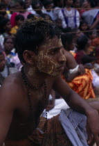 Punnaccolai Festival. Tamil Temple Guardian Sooriyakaran.  Shanthi s brother.  with turmeric paste on head and face which has a cooling effect in preparation for a fire walk. Perfomed as part of a rel...
