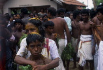 Punnaccolai Festival. Tamil Oracle named Sothimalarwith her arms wrapped around her son  both with ritual trident piercings inserted through cheeksAsia Asian Kids Llankai Religion Religious Sri Lank...