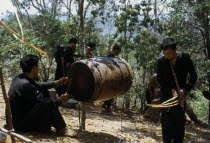 Meo men playing musical instruments during the traditional ox killing ritual Meo indigenous peopleAsian Classic Classical Historical Indegent Lao Male Man Guy Older Southeast Asia