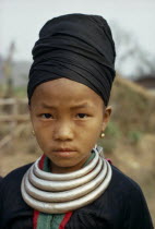 Head and shoulders portrait of a Meo girl wearing traditional dress and silver bars around her neck which are used as moneyMeo indigenous peopleAsian Classic Classical Historical Indegent Lao Older...