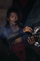 Meo man smoking Opium Meo indigenous people Asian Indegent Lao Male Men Guy One individual Solo Lone Solitary Southeast Asia