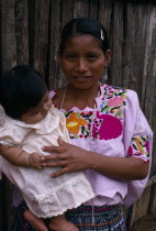Q eqchi Indian mother wearing a traditional embroidered blouse holding her baby daughter in Sacaak refugee settlement. Roman s daughter.Indigenous people American Babies Central America Classic Class...