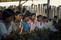 Q eqchi Indian girls holding candles at Roman Catholic MassAmerican Central America Christian Hispanic Kids Latin America Latino Religious