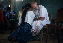 Padre Tiziano an Italian Roman Catholic missionary taking Confession with a Q eqchi Indian girl  American Central America Christian Hispanic Kids Latin America Latino Religious