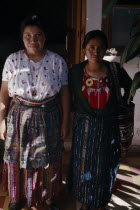 Roman Catholic Mission. Full length standing portrait of two Quiche Indian widows who run the Conavigua Association a committee of Guatemalan Indigenous widows of men killed during the civil war.2 Am...