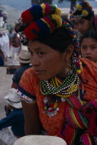 Quiche Indian woman wearing traditional colourful dress with beaded necklaces and elaborate head-dress at the San Andres festivalAmerican Central America Classic Classical Colorful Female Women Girl...