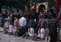 Quiche Indians knelling in prayer to saints outside the 16th century church during San Andres Festival on December 8thAmerican Central America Hispanic Latin America Latino Religious