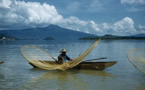 Fishermen butterfly net fishing from canoes on Lake PatzcuaroAmerican Hispanic Latin America Latino Mexican One individual Solo Lone Solitary