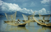 Fishermen butterfly net fishing from canoes on Lake PatzcuaroAmerican Hispanic Latin America Latino Mexican Southern