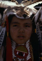 Blackfoot Native American Tribe. Portrait of a young participant at Pow Wow wearing tribal dress including a wolf head-dressCanadian Immature Indigenous Kids North America One individual Solo Lone So...