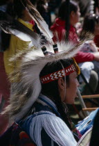Blackfoot Native American Indian child wearing tribal dress with other plains Indians at Pow WowCanadian Children Indigenous Kids North America